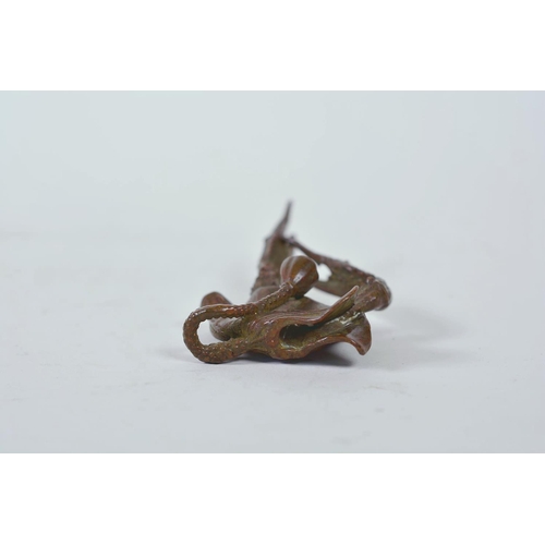 11 - An unusual Chinese bronzed metal model of a mythical creature, together with a parrot letter opener,... 