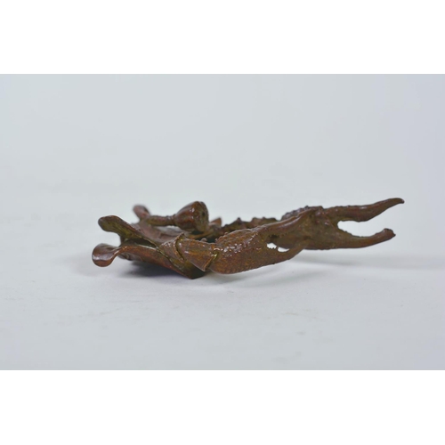 11 - An unusual Chinese bronzed metal model of a mythical creature, together with a parrot letter opener,... 