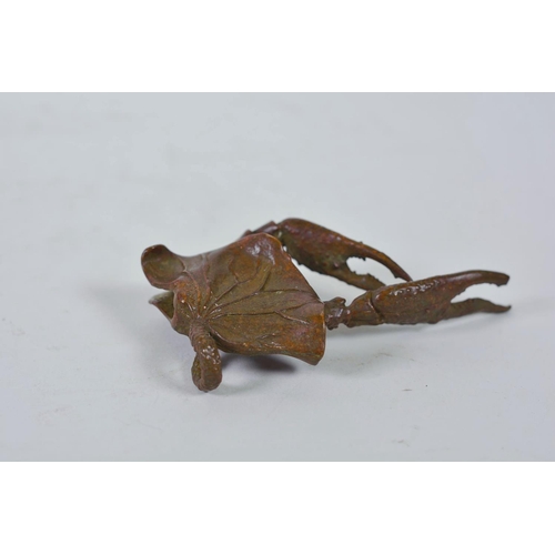 11 - An unusual Chinese bronzed metal model of a mythical creature, together with a parrot letter opener,... 