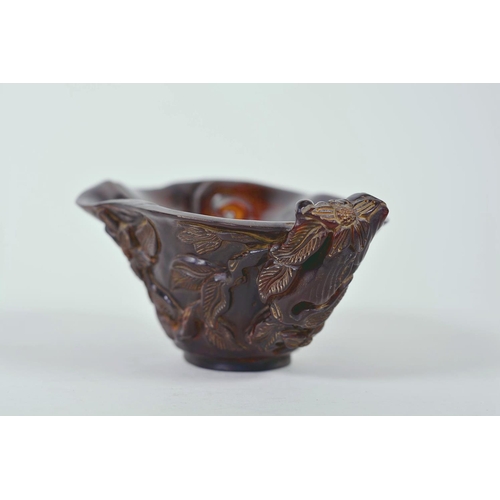 15 - A Chinese faux horn libation cup with carved floral decoration, chased mark to base, 4½