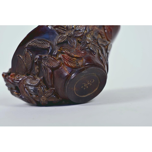 15 - A Chinese faux horn libation cup with carved floral decoration, chased mark to base, 4½