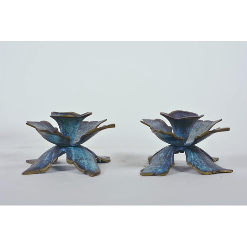 17 - A pair of verdigris brass dwarf candlesticks on petal shaped bases, 3