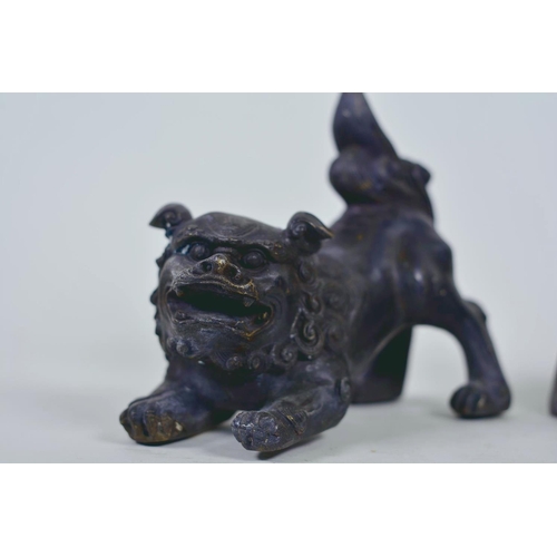 19 - A pair of Oriental patinated bronze figures of fo dogs, 6