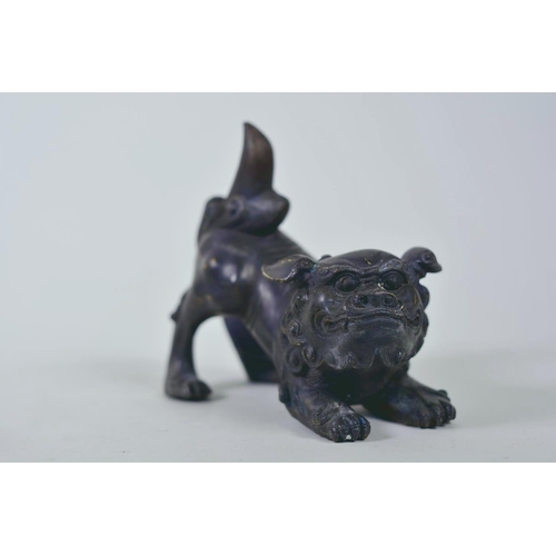 19 - A pair of Oriental patinated bronze figures of fo dogs, 6