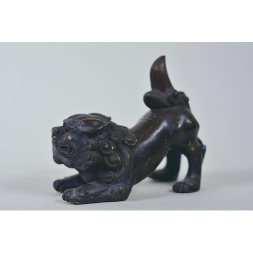 19 - A pair of Oriental patinated bronze figures of fo dogs, 6