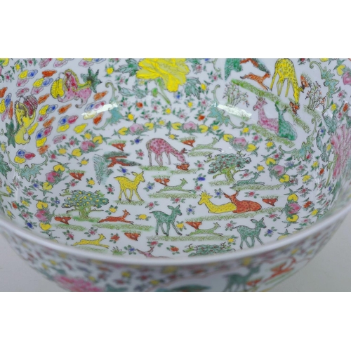 21 - A large Chinese porcelain bowl decorated with deer, mythical beasts and flowers in bright enamels, 1... 