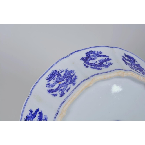 25 - A Chinese Ming style blue and white porcelain dish with lobed sides and dragon decoration, 6 charact... 