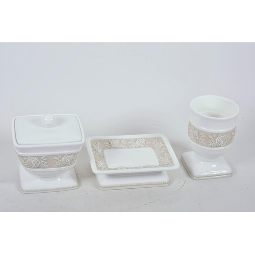 27 - A Swedish porcelain dressing table trio of trinket box, pin tray and vase with embossed floral decor... 