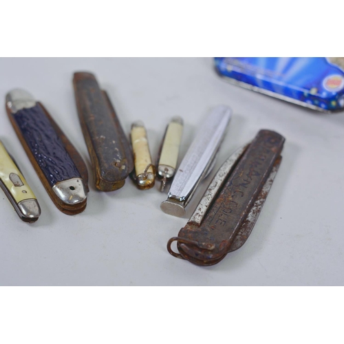 3 - A collection of seven various penknives in a Burger King 'ET' collector's tin