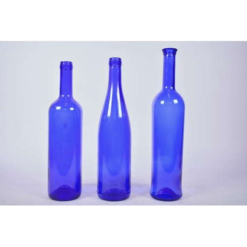 31 - Three 1970s blue glass bottles, largest 13