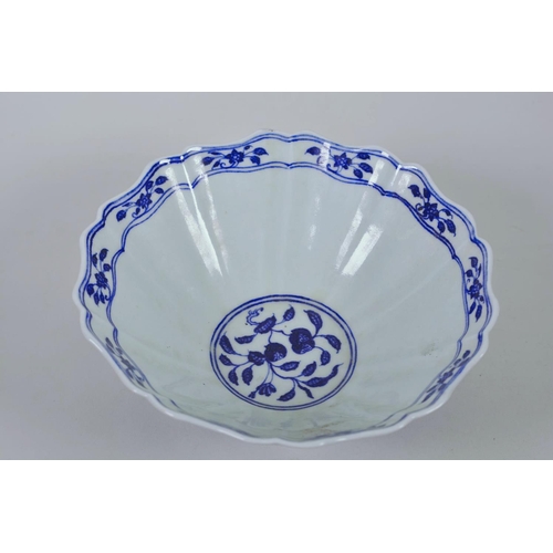 38 - A Chinese blue and white porcelain bowl with a lobed rim and dragon decoration, 6 character mark to ... 