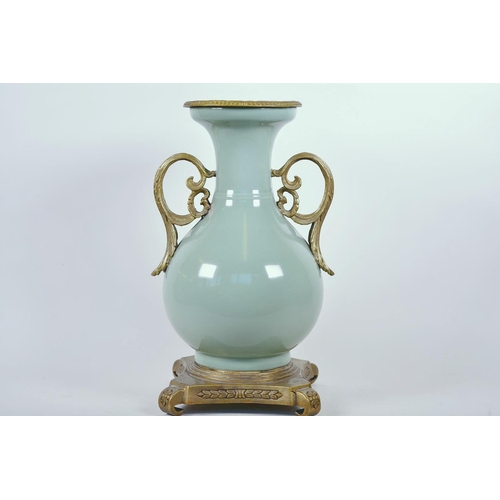 43 - A Chinese celadon glazed porcelain vase with ormolu style mount and raised floral decoration, seal m... 