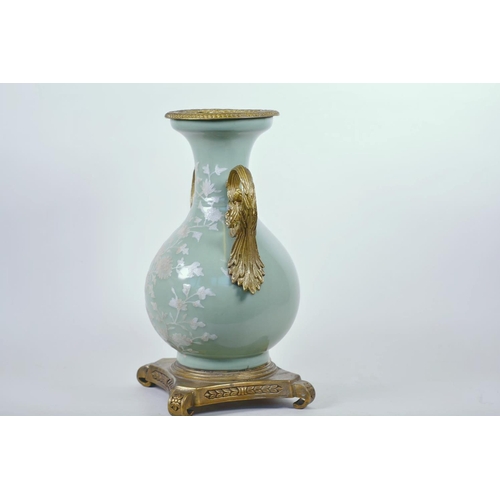 43 - A Chinese celadon glazed porcelain vase with ormolu style mount and raised floral decoration, seal m... 