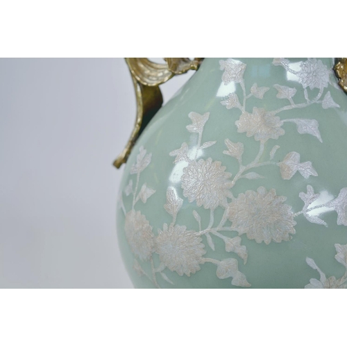 43 - A Chinese celadon glazed porcelain vase with ormolu style mount and raised floral decoration, seal m... 