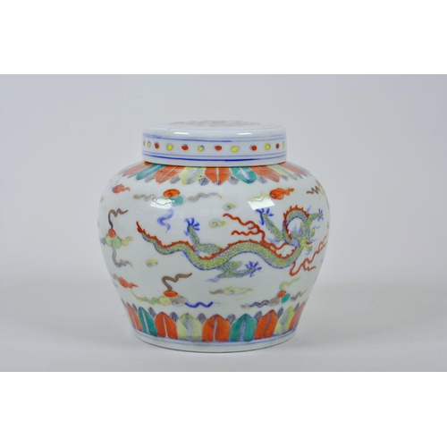 45 - A Chinese doucai porcelain ginger jar and cover, decorated with dragons chasing the flaming pearl, 5... 