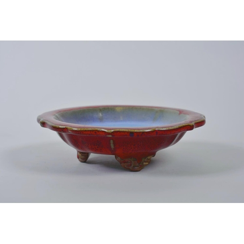 48 - A Chinese Jun ware dish on tripod feet with a lobed rim and flambé glaze, mark to base, 6½