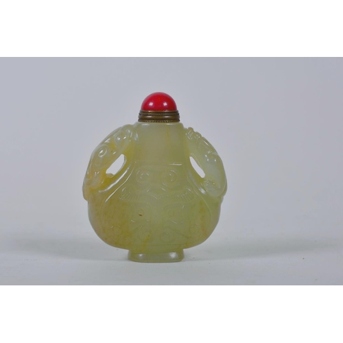 61 - A Chinese celadon jade snuff bottle with two carved kylin handles, 2½