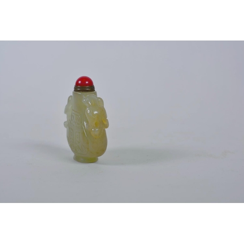 61 - A Chinese celadon jade snuff bottle with two carved kylin handles, 2½