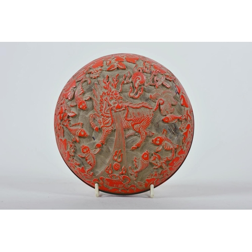 66 - A Chinese cinnabar lacquer box, the cover carved with exotic beast and fish amongst water plants, se... 