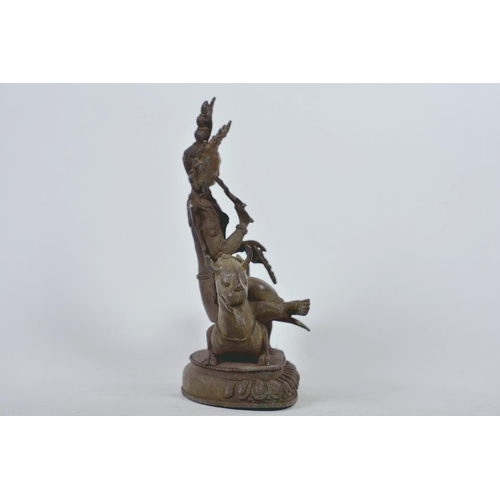 34 - A Chinese patinated bronze figure of Buddha seated on a mythical beast, 10