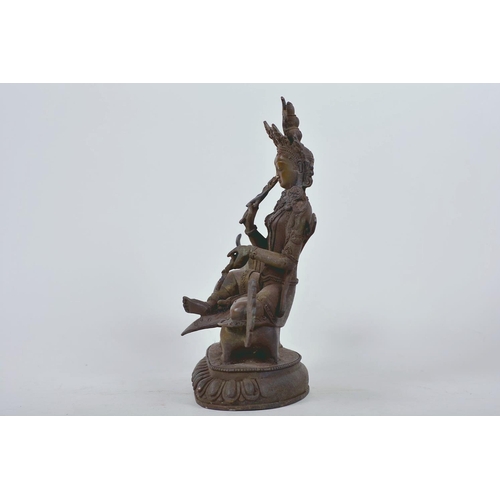 34 - A Chinese patinated bronze figure of Buddha seated on a mythical beast, 10