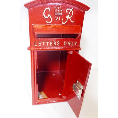 17 - A cast iron and metal postbox with key, 23