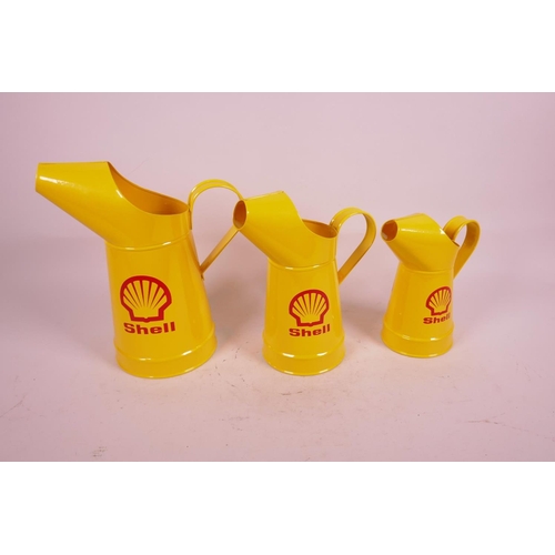 2 - A set of three replica oil jugs decorated with the Shell logo, largest 10