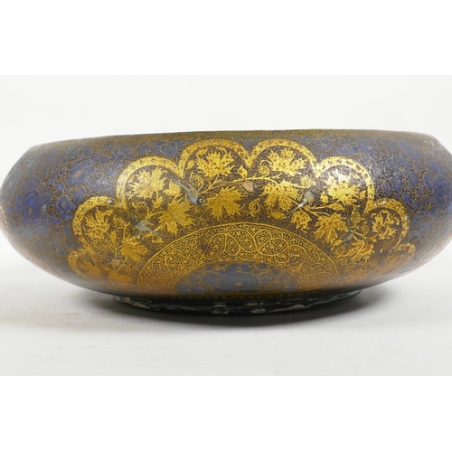 26 - A Kashmiri brass and lacquer bowl with a rolled rim, decorated with gilt floral patterns, signed to ... 