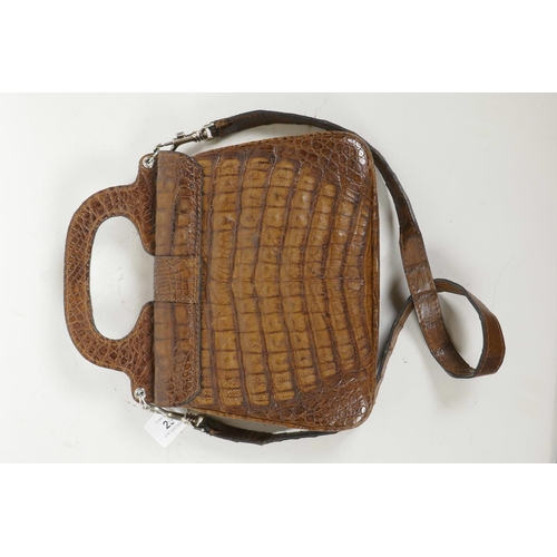 29 - A crocodile skin handbag by Jaguar, with shoulder strap, 9½