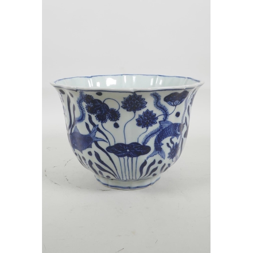 35 - A Chinese blue and white porcelain bowl with a lobed rim, decorated with carp in a lotus pond, six c... 