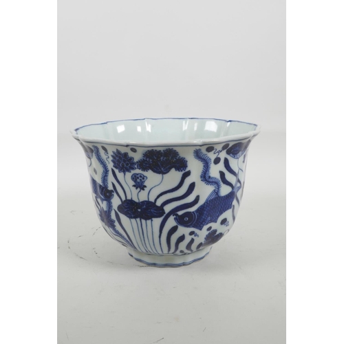 35 - A Chinese blue and white porcelain bowl with a lobed rim, decorated with carp in a lotus pond, six c... 