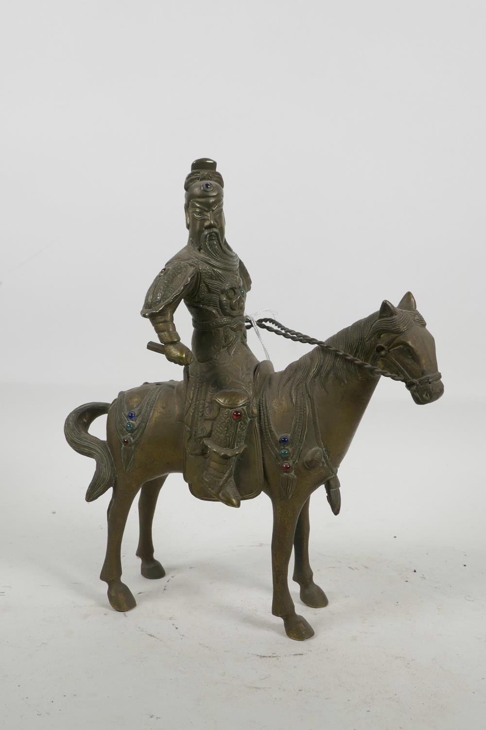 A Mongolian brass figurine of a warrior on horseback with