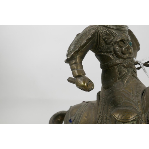 A Mongolian brass figurine of a warrior on horseback with