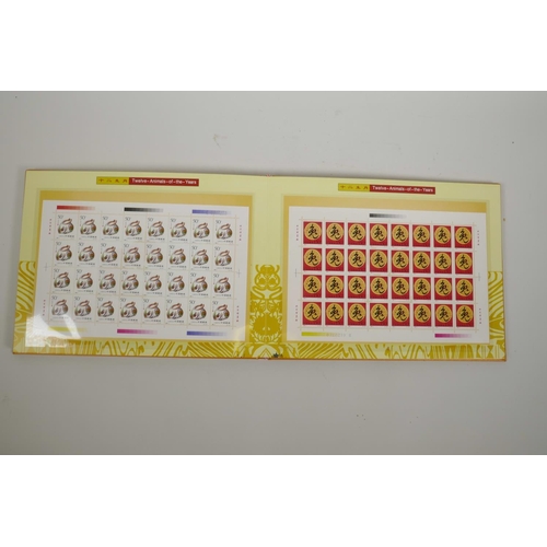 40 - An album of Chinese facsimile (replica) stamp sheets depicting the twelve animals of the Zodiac, dat... 