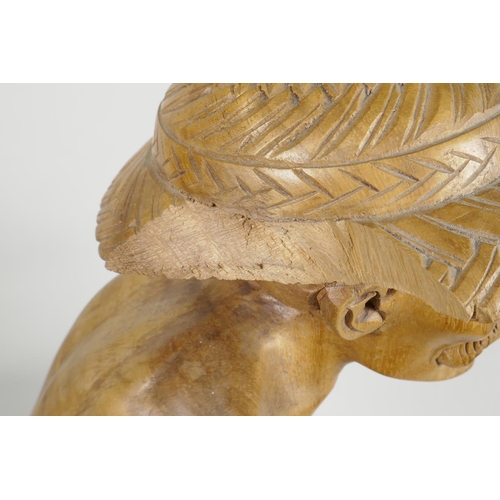 47 - An oriental carved wood figure of a fisherman with large fish, seated on a coral reef, 21