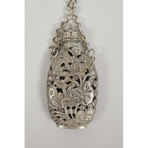 5 - A Chinese white metal scent holder with pierced decoration of carp and lotus flowers, 6½