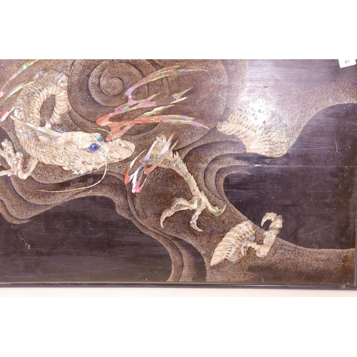 61 - An oriental lacquered panel, with bronzed and inlaid mother of pearl decoration of a dragon in storm... 