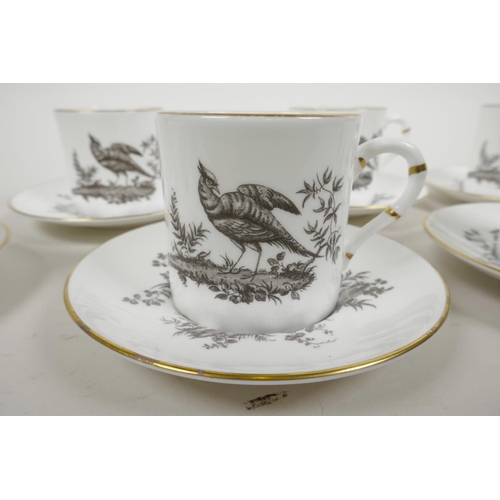 12 - A Royal Worcester porcelain coffee service comprising six cups and saucers with monochrome decoratio... 