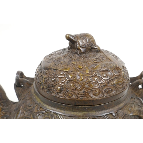 18 - A Chinese bronze teapot with raised decoration of cranes in flight, four character mark to base, 5½