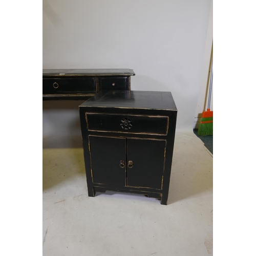 1827 - A Chinese style black lacquer bedroom suite comprising two bedside cabinets and a two drawer side ta... 