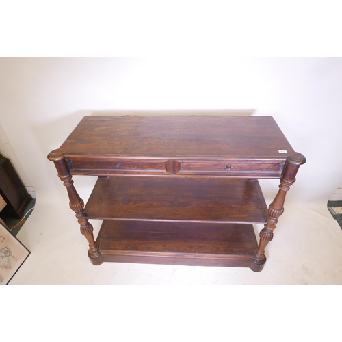 1832 - A C19th French rosewood three tier buffet, with two frieze drawers, raised on turned and carved supp... 