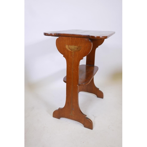 1843 - An Art Nouveau oak two tier occasional table with harewood inlay decoration to ends and shaped top, ... 