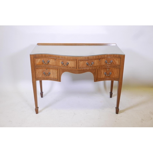 1856 - A C19th inlaid figured mahogany serpentine fronted kneehole desk of four drawers, raised on tapering... 