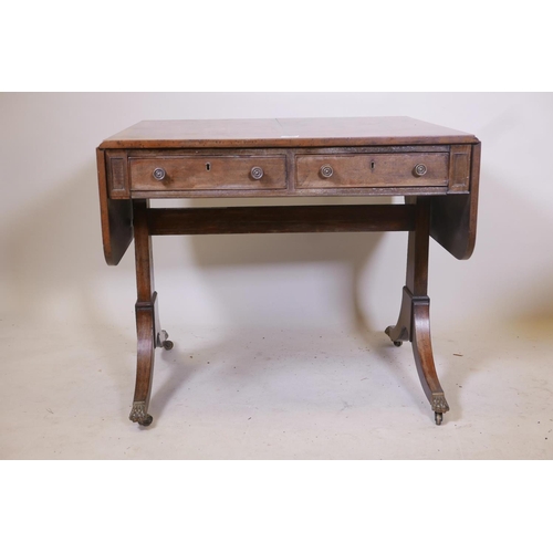 1858 - A Regency mahogany sofa table with two true and two false drawers raised on end supports, 33