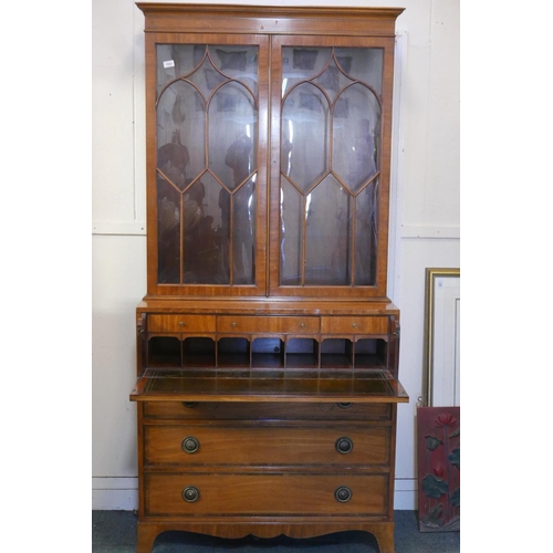 1863 - A Regency style satinwood secretaire bookcase, with astragl glazed top, base with interior fitted wi... 