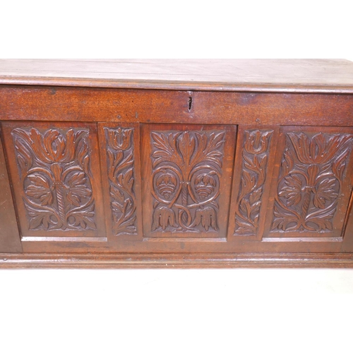 1864 - An C18th oak triple panel coffer with carved decoration, 55