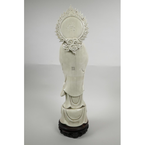 23 - A Chinese blanc de chine Quan Yin on a lotus flower, on an associated hardwood stand, impressed seal... 