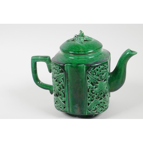 27 - A Chinese green glazed porcelain teapot, the body decorated with pierced reticulated panels of leave... 