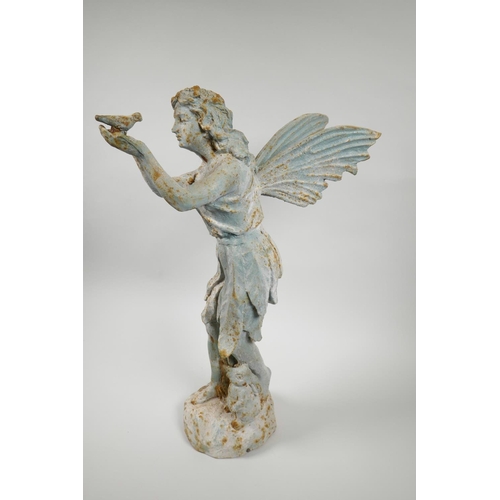 29 - A cast metal garden figure of a fairy holding a bird, 20