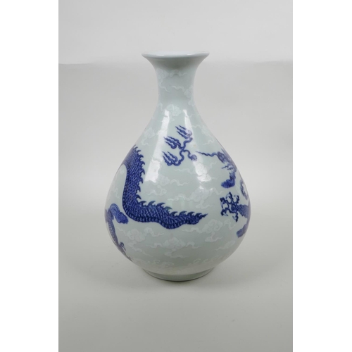 33 - A Chinese blue and white porcelain pear shaped vase decorated with a dragon in flight, six character... 